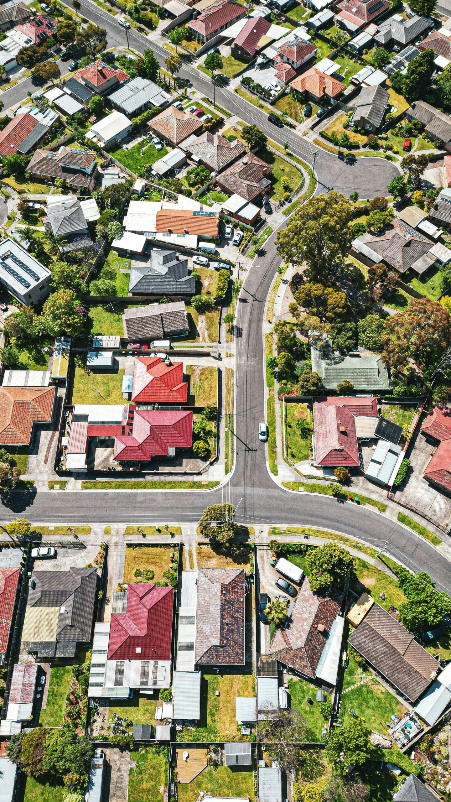 Drone shot of a vibrant Melbourne suburb showcasing houses and streets from above.